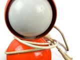 an orange and white object with a light attached to it