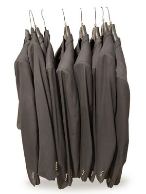 a lot of jackets hanging on a rack on a white background