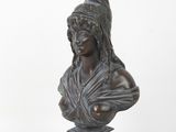bronze bust of a woman with a helmet on her head