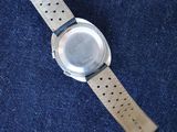 an image of a watch sitting on top of a blue cloth
