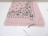 a pink scarf with a dog on it on a table