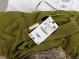 a bag of clothes and a pair of scissors on a bed