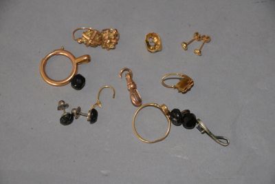 a lot of gold and black jewelry on a table