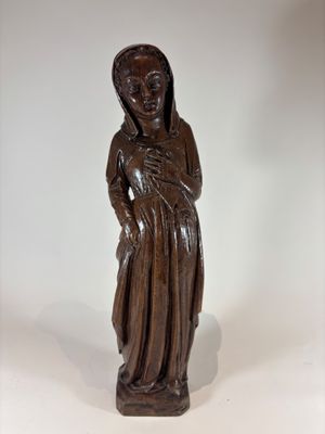 wooden statue of a woman holding a baby in her arms