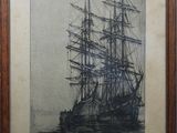 an old picture of a ship in the water in a wooden frame