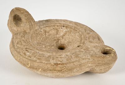 a small stone object that is sitting on a white surface