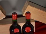 two bottles of wine sitting next to each other on a table