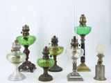 many different types of glass lamps on the table