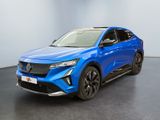 a blue electric suv parked in a room with a black floor