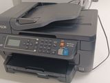 a printer sitting on top of a counter next to a printer