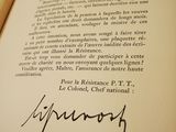 a close up of a book with a signature on it