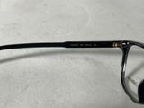 a pair of glasses sitting on a white surface