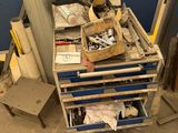 a cart with tools on top of it next to a chair