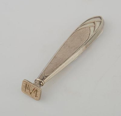 a close up of a silver spoon with a number on it