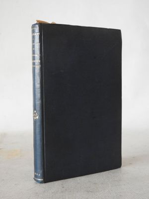 a black book with a blue cover sitting on top of a table