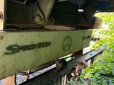 a close up of a green truck with a logo on it