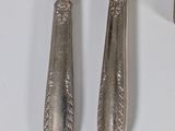 two forks and a knife hanging on a wall
