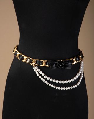 a close up of a mannequin belt with pearls on it