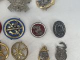 some of the military badges are laying out on a white surface