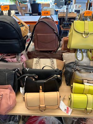 a lot of purses on a table in a store