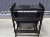 an image of a black chair in front of a metal wall