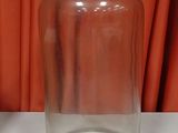 a clear glass jar with a wooden lid on a table