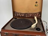 a brown suitcase with a record player inside of it