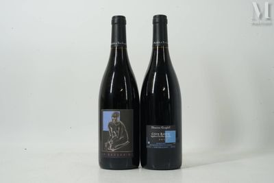 two bottles of wine sitting next to each other on a table