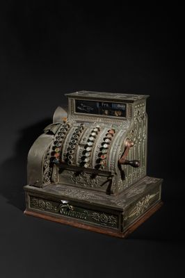 an old fashioned cash register sitting on top of a black surface