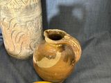 three vases are sitting next to each other on a blue cloth