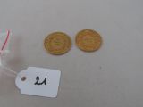 two coins and a price tag sitting on a table