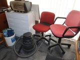 two red chairs in the corner of a room