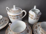 four cups and a saucer on the table
