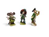 three figurines of a man playing a trumpet, a woman playing a trumpet, and a man playing a trumpet