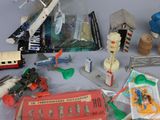 a table with a lot of toys on it that include a plane, a train, a train, a bus, a train, and a train