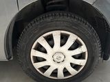 a close up of a car ' s tire on the side of the road