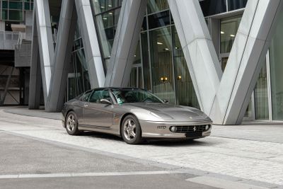 a silver car that is parked in front of a building