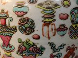 a vase with a design on it sitting on a table