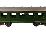 a green train car that is sitting on a white surface