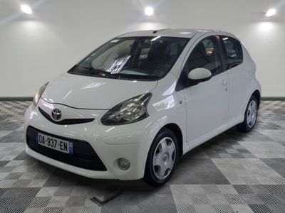 a small white car parked on a checkered floor