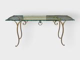 a table with a glass top and metal legs