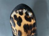 a close up of a shoe with a leopard print on it