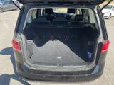 the back of a car with its trunk open in a parking lot