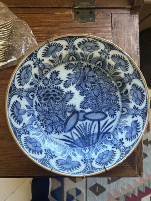 a blue and white plate sitting on a wooden table