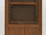 an old wooden cabinet with a glass door and shelves