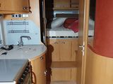 a small kitchen with a sink and a stove in it