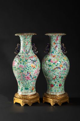 pair of chinese vases on stands on a black background