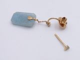 gold plated earring with a blue stone and a gold plated earring on a white background