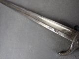 a very old sword that is laying on a table