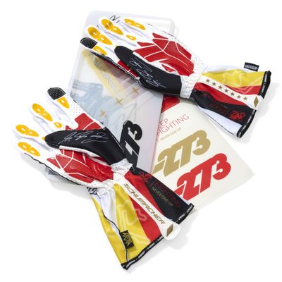 three pairs of gloves with yellow and red designs on them